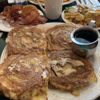The Frog Pond - Cinnamon roll French toast, potatoes, and bacon. - Breakfast & Brunch Near Me - St Pete Beach, Florida The Frog Pond - Cinnamon roll French toast, potatoes, and bacon. - Breakfast & Brunch Near Me - St Pete Beach, Florida