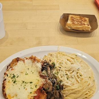 WD Cravings - Cheese Wheel pasta with chicken parmasean and mushrooms, accompanied with a side of toast. - Breakfast & Brunch Near Me - Omaha, Nebraska WD Cravings - Cheese Wheel pasta with chicken parmasean and mushrooms, accompanied with a side of toast. - Breakfast & Brunch Near Me - Omaha, Nebraska