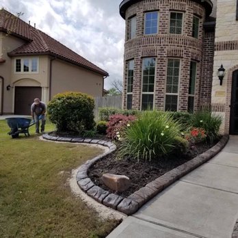 TexStar Curb & Borders - a man with a wheelbarrow - Landscaping Near Me TexStar Curb & Borders - a man with a wheelbarrow - Landscaping Near Me