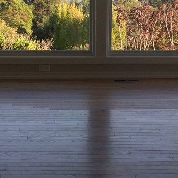 Empire Today - Living room by Empire. Mismatched finishes across boards.  Supposed to be all "satin"  Notice the flat area of "no sheen" towards the back. - Carpet Installation Near Me