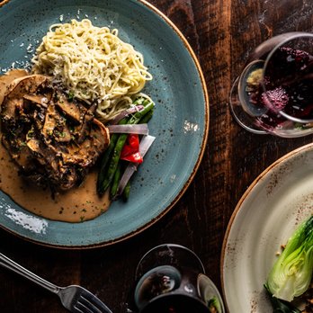 Milestones - two plates of food and a glass of wine - Bars Near Me - Calgary, Alberta Milestones - two plates of food and a glass of wine - Bars Near Me - Calgary, Alberta