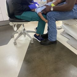 Greater Houston Pediatric Dentistry - My son being held by my lover and the dental assistant while she looks at his teeth