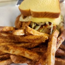 Salads On Demand - This is a fried whiting sandwich with our smoky & savory cheese, lettuce, and hot sauce served with our signature fries.