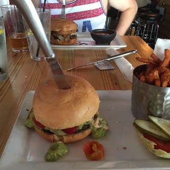 Engine No 9 - Border Line Burger and sweet potato fries, Wine-o burger in the background with baked beans - Burgers Near Me - Saint Petersburg, Florida Engine No 9 - Border Line Burger and sweet potato fries, Wine-o burger in the background with baked beans - Burgers Near Me - Saint Petersburg, Florida