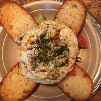 Mellow Yellow - Fried egg topped with Moroccan spices and placed over cucumbers, tomatoes, hummus, and gluten free bread. - Coffee & Tea Near Me - New York, New York Mellow Yellow - Fried egg topped with Moroccan spices and placed over cucumbers, tomatoes, hummus, and gluten free bread. - Coffee & Tea Near Me - New York, New York