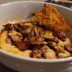 Pour Baby - CHICKEN AND GRITS chicken thighs, crispy chicken skin, stone-ground corn grits, smoked sausage, sweet chili glaze