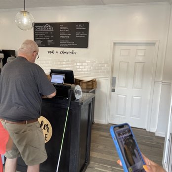 Mak & Cheesecakes - a man using a cell phone - Desserts Near Me - Simpsonville, South Carolina