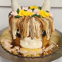 Our custom 3-layer Highland cow peanut butter cake.