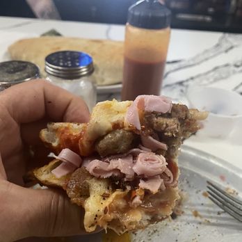 DeRussos Pizzeria - Pizza folded.  Tons of toppings - Pizza Near Me - St. Petersburg, Florida