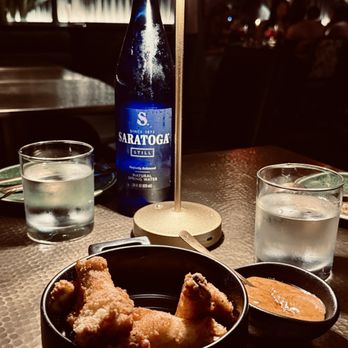 Lele - The wings with a bottle of Saratoga. - Caribbean Near Me - New York, New York