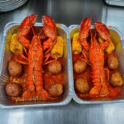 Whole lobster coated in bold Cajun garlic butter, paired with corn and seasoned potatoes for a rich, crave-worthy seafood feast.