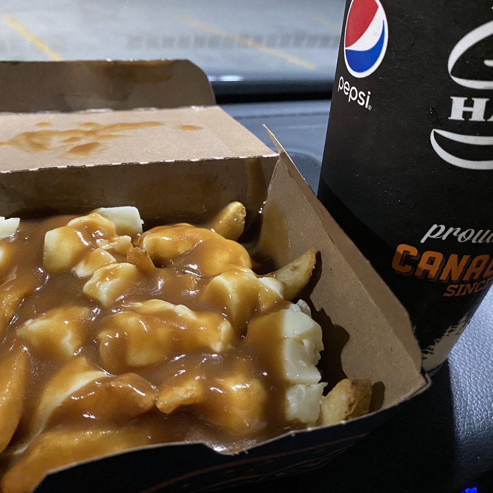 Harvey's - 3.99 late night poutine combo... not too shabby but who puts ketchup on poutine? - Burgers Near Me - Scarborough, Ontario
