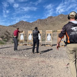 Action Shooting Academy - Instructor coaching 8 students on the firing line in Action Shooting Academy's half-day High-Speed Marksmanship class.