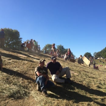 Common Ground Fair - kids sliding down hill on cardboard - Festivals Near Me - Unity, Maine