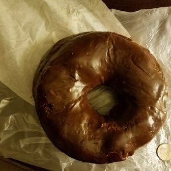 Pike Place Bakery - Size comparison of Texas sized donut to quarter. It's huge but inedible (unless you love stretchy uncooked donut dough) - Bakeries Near Me - Seattle, Washington Pike Place Bakery - Size comparison of Texas sized donut to quarter. It's huge but inedible (unless you love stretchy uncooked donut dough) - Bakeries Near Me - Seattle, Washington