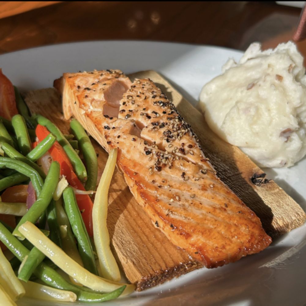 Cedar Creek Inn - Salmon on a plank with mashed potatoes and vegetables. - New American Near Me - Brea, California Cedar Creek Inn - Salmon on a plank with mashed potatoes and vegetables. - New American Near Me - Brea, California