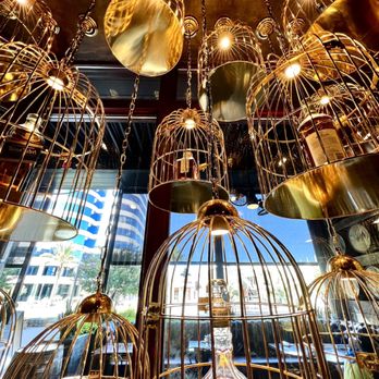 Bosscat Kitchen & Libations - Birdcages housing whiskey bottles. - New American Near Me - Irvine, California