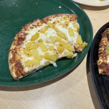 Straw Hat Pizza - a slice of pizza on a green plate - Pizza Near Me - Manteca, California