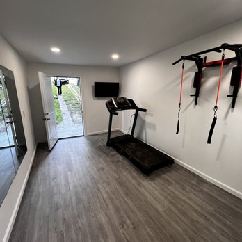 AZ Builders - a home gym with a treadmill - General Contractors Near Me AZ Builders - a home gym with a treadmill - General Contractors Near Me