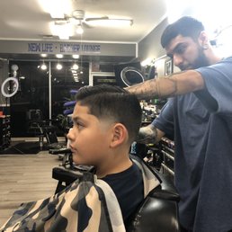 Chris the barber finishing up my sons hair Chris the barber finishing up my sons hair