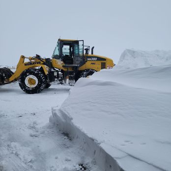 Q Lawn - a snow plow clearing a road - Landscaping Near Me Q Lawn - a snow plow clearing a road - Landscaping Near Me