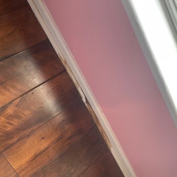 50Floor - Bucking floor boards and a stained base board - Flooring Near Me - Roswell, Georgia
