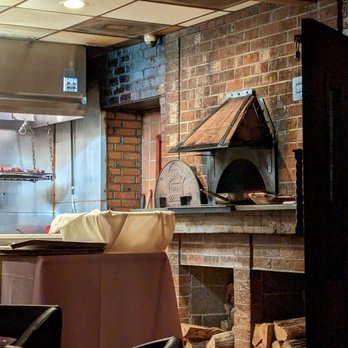 Bin 54 Steak & Cellar - Inside. Brick wood-fired oven with steaks suspended above the grill in the back. - Steakhouses Near Me - Chapel Hill, North Carolina Bin 54 Steak & Cellar - Inside. Brick wood-fired oven with steaks suspended above the grill in the back. - Steakhouses Near Me - Chapel Hill, North Carolina