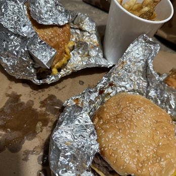 Five Guys - A lot of grease look at how sloppy the burgers were put together , I wanted one plain  nope 3 so messy - Fast Food Near Me - New Lenox, Illinois