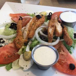 a plate of salad with dressing a plate of salad with dressing