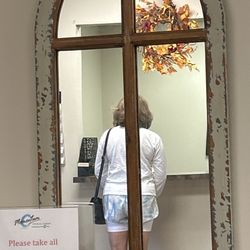 Momentum Physical Therapy - Mirror w/picture in reflection of an individual
