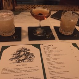 two cocktails and a menu on a table