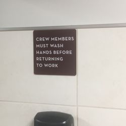 Wendy's - While using the restroom an employee came out of the stall and missed this sign on his way out! Decided to skip ordering food.