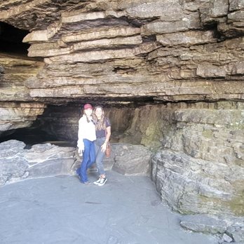 The Jack Daniel Distillery - a man and a woman standing in a cave - Distilleries Near Me - Lynchburg, Tennessee