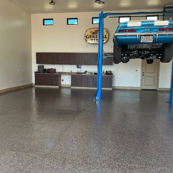 StoneCoat Floors - a car on a lift in a garage - Flooring Near Me StoneCoat Floors - a car on a lift in a garage - Flooring Near Me