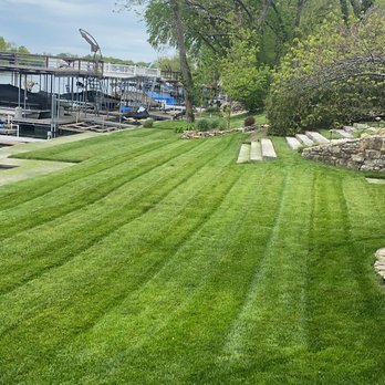Aubrey Hills - a view of a lawn with a boat dock in the background - Lawn Services Near Me Aubrey Hills - a view of a lawn with a boat dock in the background - Lawn Services Near Me