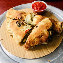 Ridiculously DELICIOUS calzone, with vegan sausage & cheese, mushrooms, spinach, onions, and jalapeños. Ridiculously DELICIOUS calzone, with vegan sausage & cheese, mushrooms, spinach, onions, and jalapeños.