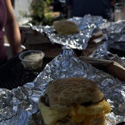 Sausage egg cheese biscuit . Honey butter