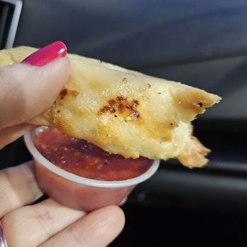 Sparky's Pizza - a hand holding a piece of pizza - Pizza Near Me - Portland, Oregon Sparky's Pizza - a hand holding a piece of pizza - Pizza Near Me - Portland, Oregon