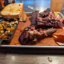 Meat Mitch Barbecue - Half eaten half rack of ribs, summer squash with goat cheese, pickles and pickled onion strings.