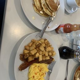 a breakfast of pancakes, eggs, hash browns and coffee a breakfast of pancakes, eggs, hash browns and coffee