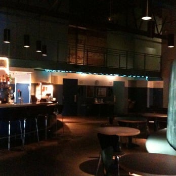 Ciné - a dimly lit bar with tables and stools - Cinema Near Me - Athens, Georgia