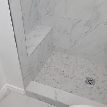Elite Restoration & Construction Services - a white marble shower - Damage Restoration Near Me