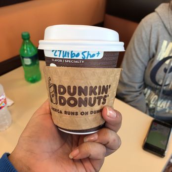 Dunkin' - a person holding a cup of coffee - Donuts Near Me - Biloxi, Mississippi Dunkin' - a person holding a cup of coffee - Donuts Near Me - Biloxi, Mississippi