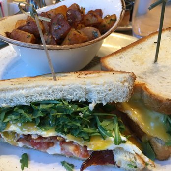 Woven + Bound Restaurant - Wisconsin Cheddar Broken Yolk Sandwich: noble star ranch bacon, avocado, tomato, aioli, sourdough, side of fruit - Bars Near Me - Chicago, Illinois