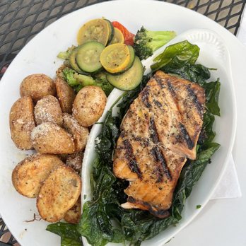 Railshake - Salmon over flash fried spinach, roasted potatoes and fresh veggies. - Bars Near Me - Highland, Illinois