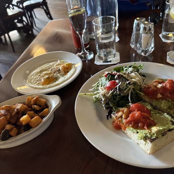 The Tavern - Avocado toast (with eggs on the side) and a side of brunch potatoes - American Near Me - Tulsa, Oklahoma