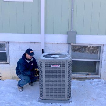 Tennessee Home Solutions - a man working on an air conditioner - Electricians Near Me - Martin, Tennessee Tennessee Home Solutions - a man working on an air conditioner - Electricians Near Me - Martin, Tennessee