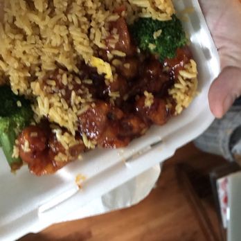 China Garden - a person holding a container of rice and broccoli - Chinese Near Me - Whitmore Lake, Michigan China Garden - a person holding a container of rice and broccoli - Chinese Near Me - Whitmore Lake, Michigan