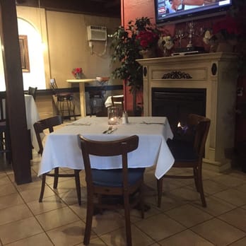 Millonzi's - a dining room with a fireplace - Burgers Near Me - West Warwick, Rhode Island Millonzi's - a dining room with a fireplace - Burgers Near Me - West Warwick, Rhode Island