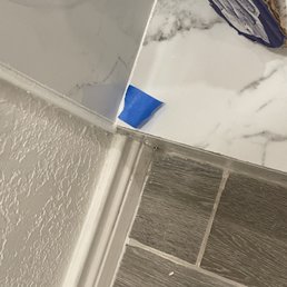 poorly trying to cover up wrong grout color, more unfinished tile edges